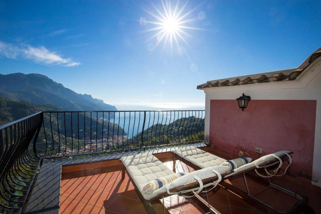 a balcony with a bench on top of a building at Casa Rossa in Ravello