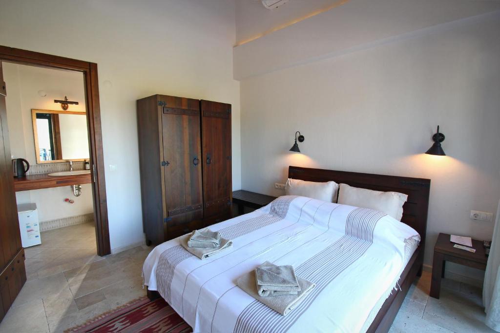 Postel nebo postele na pokoji v ubytování Kekik Otel Selimiye