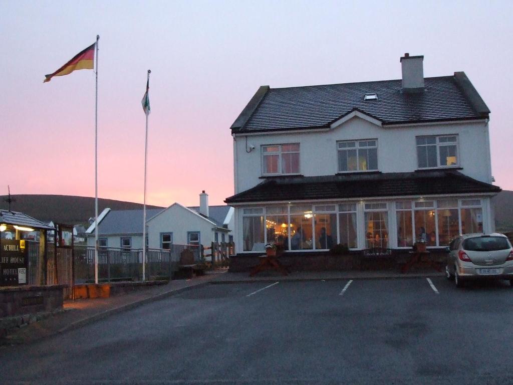 een huis met een auto geparkeerd op een parkeerplaats bij Achill Cliff House Hotel & Restaurant in Keel