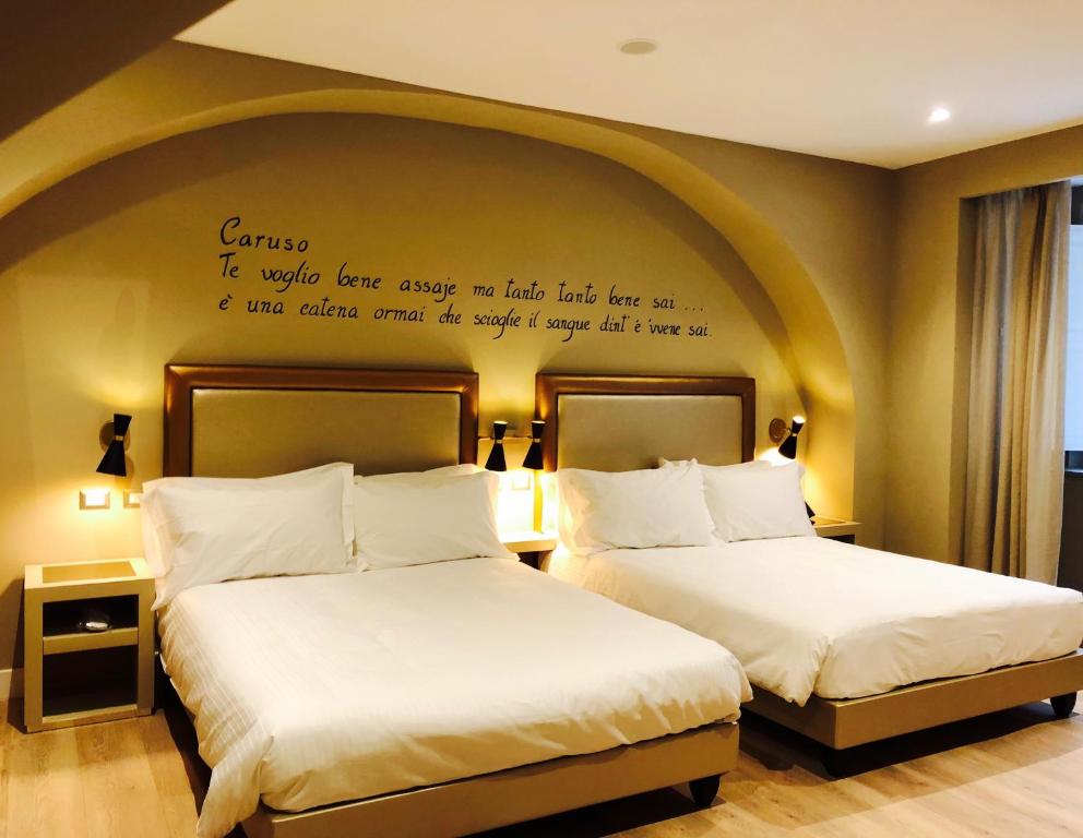 Łóżko lub łóżka w pokoju w obiekcie Caruso Place Boutique & Wellness Suites