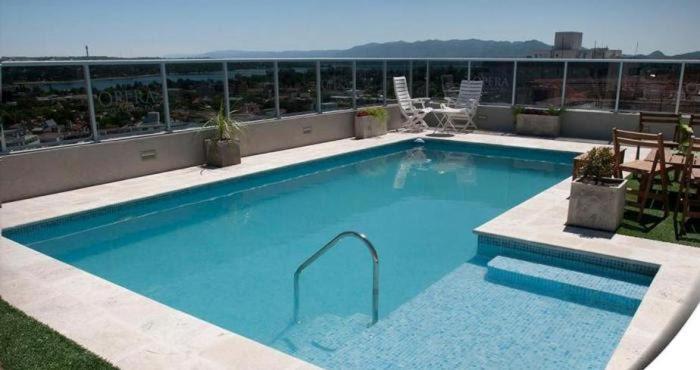 a large swimming pool on top of a building at Opera Villa Carlos Paz in Villa Carlos Paz