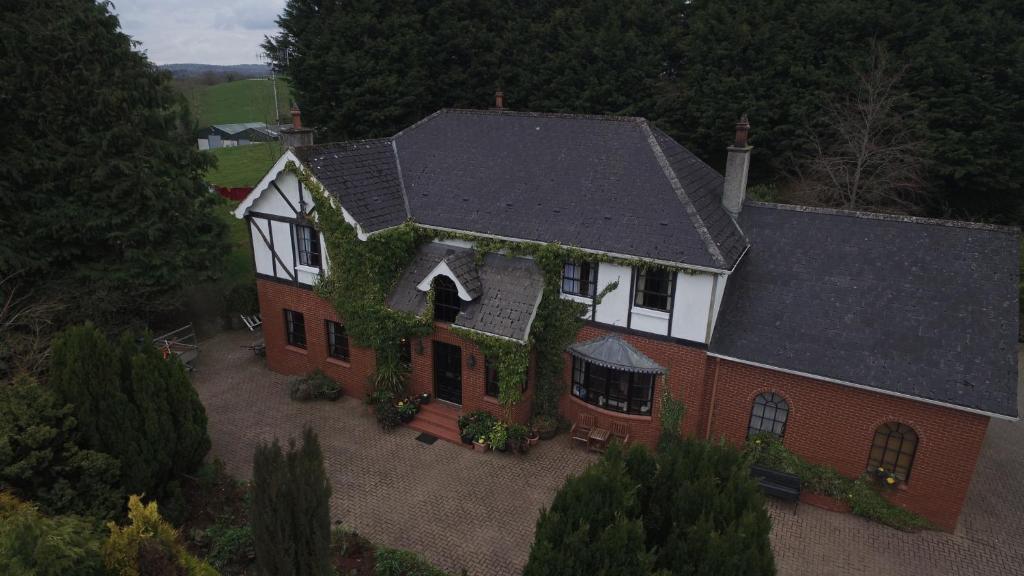 an aerial view of a house with ivy on it at Pinewood Lodge Guest House in Omagh