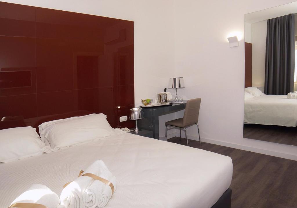 Postel nebo postele na pokoji v ubytování Hotel Leopardi