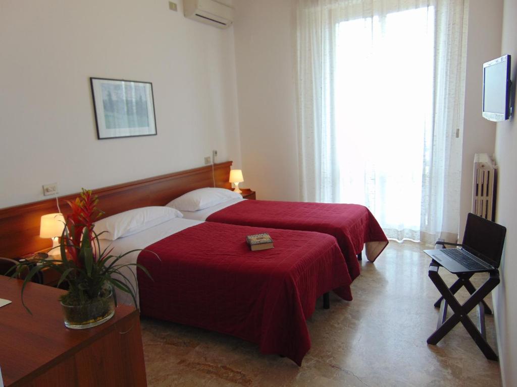 Postel nebo postele na pokoji v ubytování Albergo Rossana