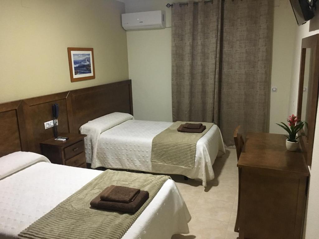 Postel nebo postele na pokoji v ubytování Hotel Don Juan