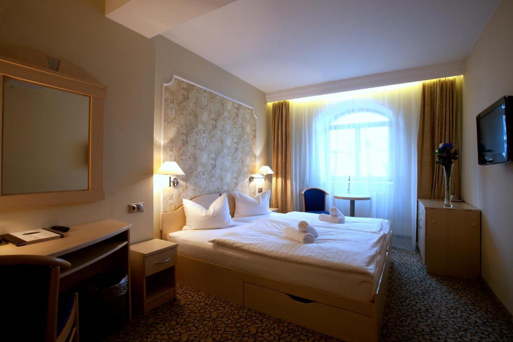 Postel nebo postele na pokoji v ubytování Hotel Ambiente Wellness & Spa