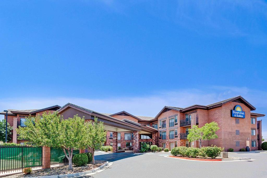 
a large building with a clock on the front of it at Days Inn & Suites by Wyndham Page Lake Powell in Page
