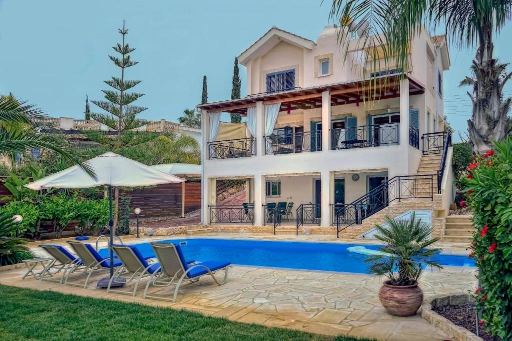 a villa with a swimming pool and a house at Sandy Beach Villa in Polis Chrysochous