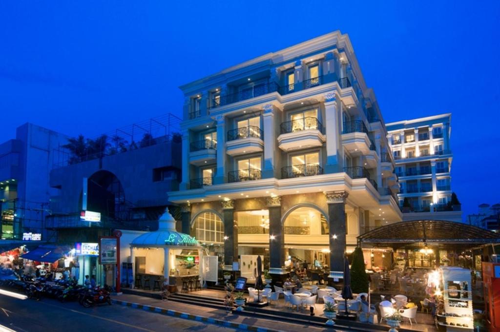 a large building with tables and chairs in front of it at LK The Empress in Pattaya Central