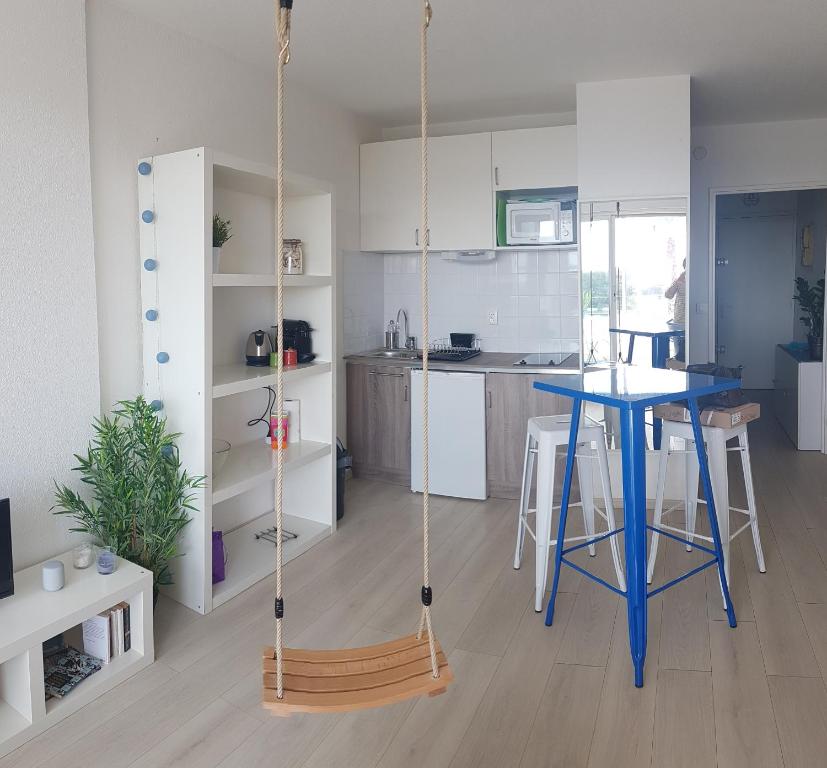 a room with a swing in a kitchen with a table at Sea Swing and Sun in La Ciotat