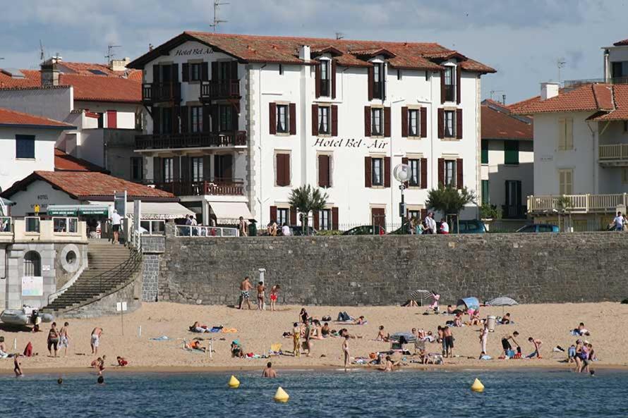 a group of people on a beach near the water at Hotel Bel Air in Saint-Jean-de-Luz