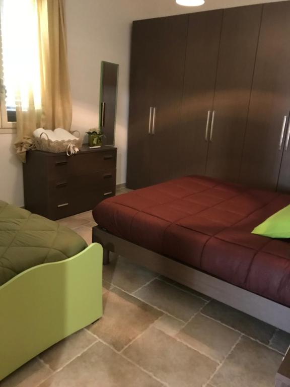 a bedroom with a bed and a dresser at Casa Vacanza Elvira Porto Selvaggio in Santa Caterina di Nardò