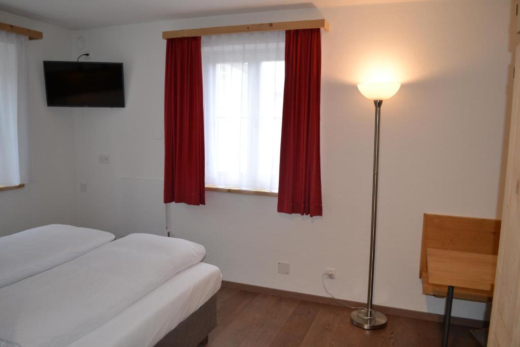 Postel nebo postele na pokoji v ubytování B&B Chasa Arfusch