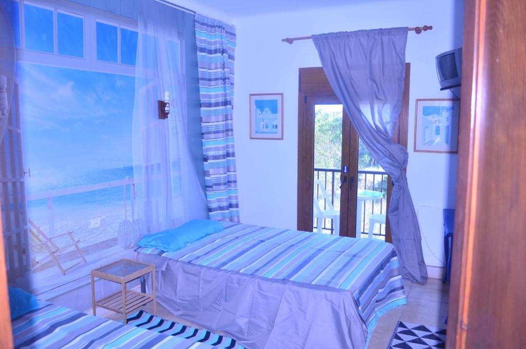 a bedroom with a bed and a view of the ocean at Residencia Santiago Mallorca in Cala Figuera