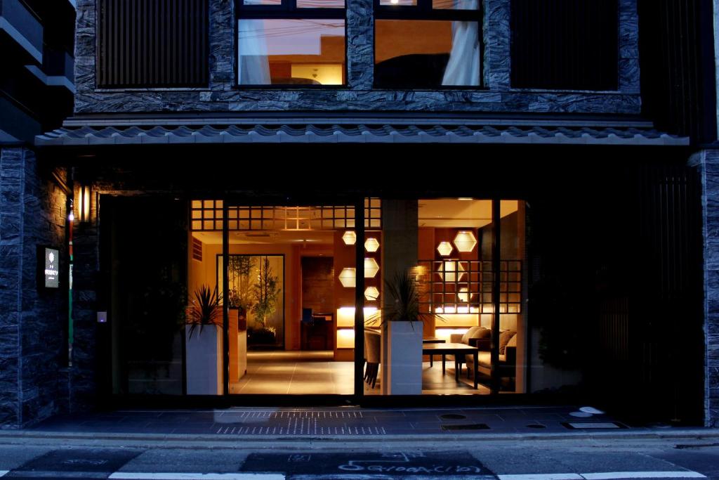 un edificio con una puerta abierta con una mesa. en Kyoto Shinmachi Rokkaku Hotel grandereverie en Kyoto