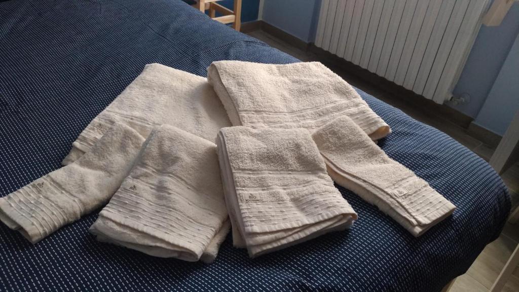 einen Stapel Handtücher auf dem Bett in der Unterkunft La rosa dei venti in Legnano
