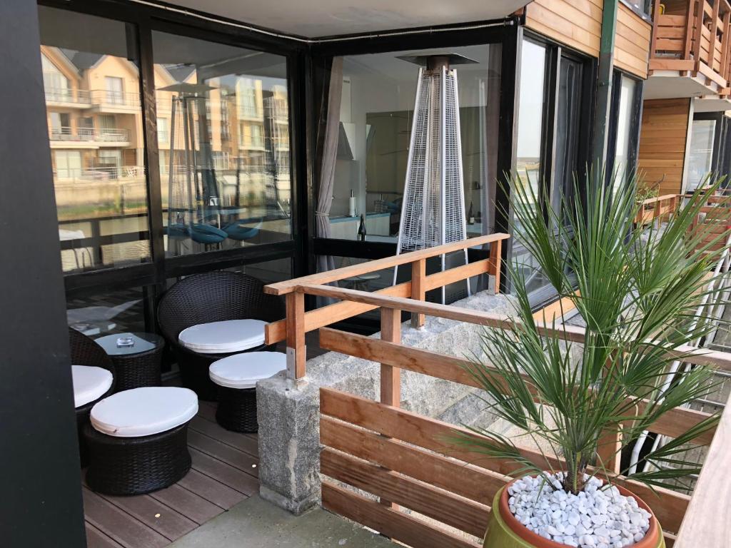 a screened in porch with toilets and a swing at MARINA 177 DEAUVILLE in Deauville