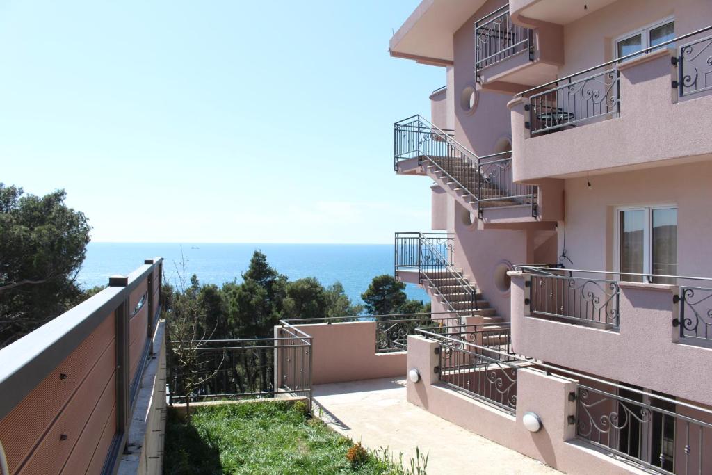 a building with balconies and the ocean in the background at Vila POGLED in Bar