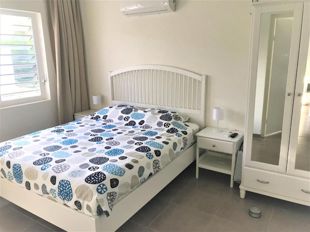 a bedroom with a bed with a blue and white comforter at Blije Rust 10 in Willemstad