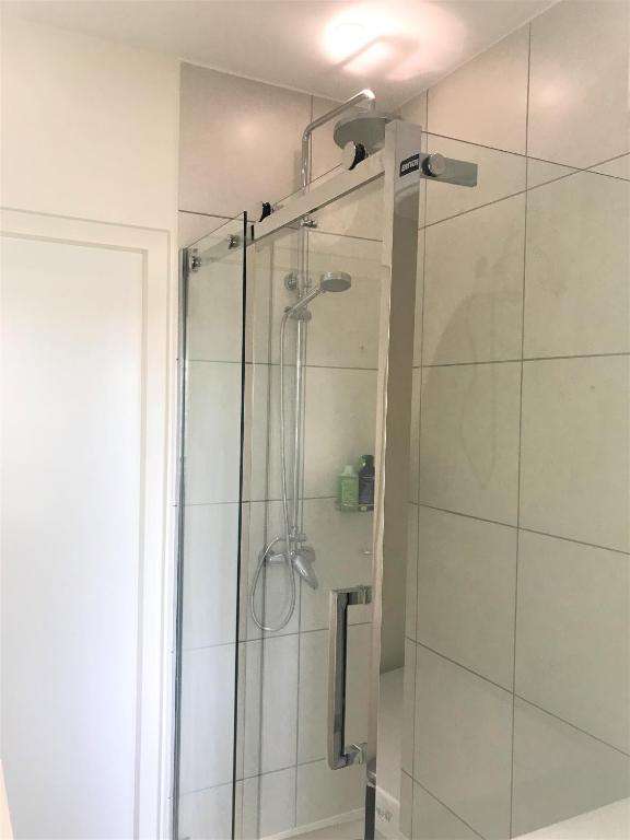 a bathroom with a shower with a glass door at Blije Rust 10 in Willemstad
