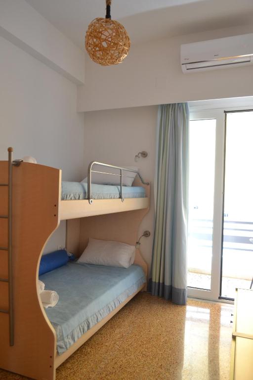 a bedroom with two bunk beds and a window at Asimelia Luxury Apartment in Heraklio Town