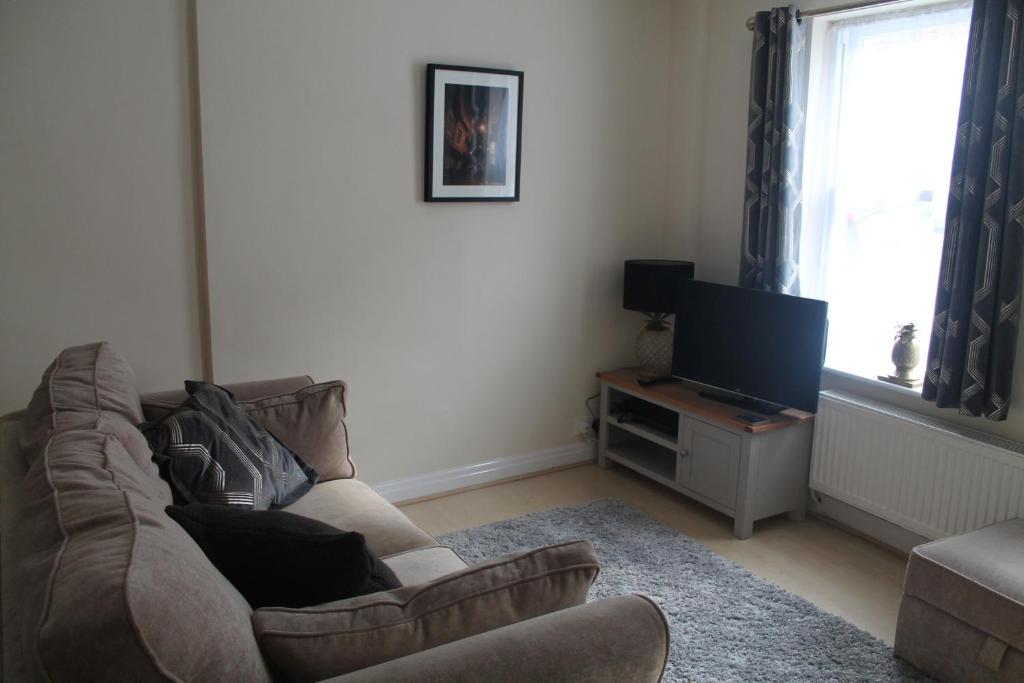 a living room with a couch and a television at Kyme Street, central York in York