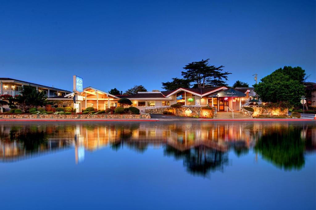 a lake with a house and some boats in it at Monterey Bay Lodge in Monterey