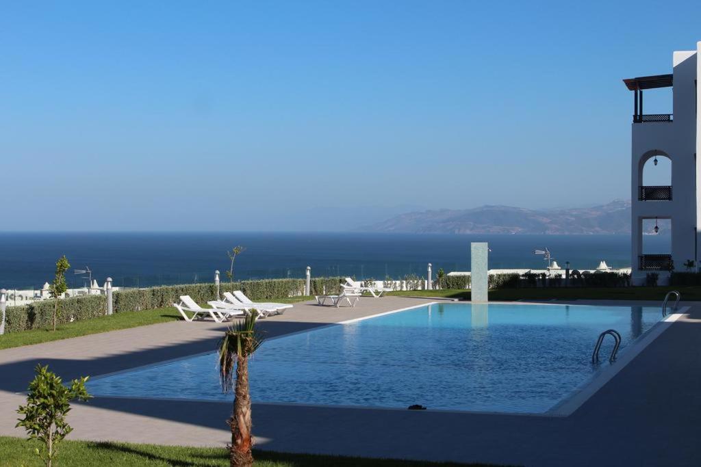 a swimming pool with a view of the ocean at Lovely family Apartment in Cabonegro, Bella Vista in Cabo Negro