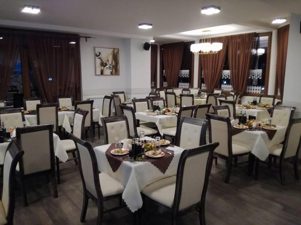 a dining room with tables and chairs in a restaurant at Hotel Scorpion in Kruševo
