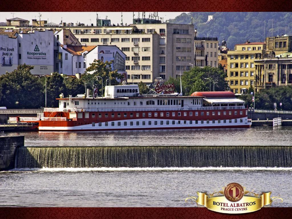 a large boat in the water in a city at Botel Albatros in Prague