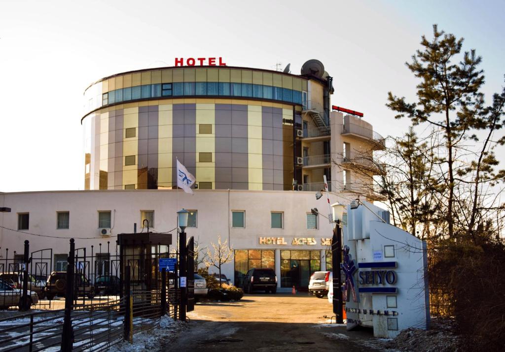 a hotel building with a sign on top of it at Acfes-Seiyo Hotel in Vladivostok