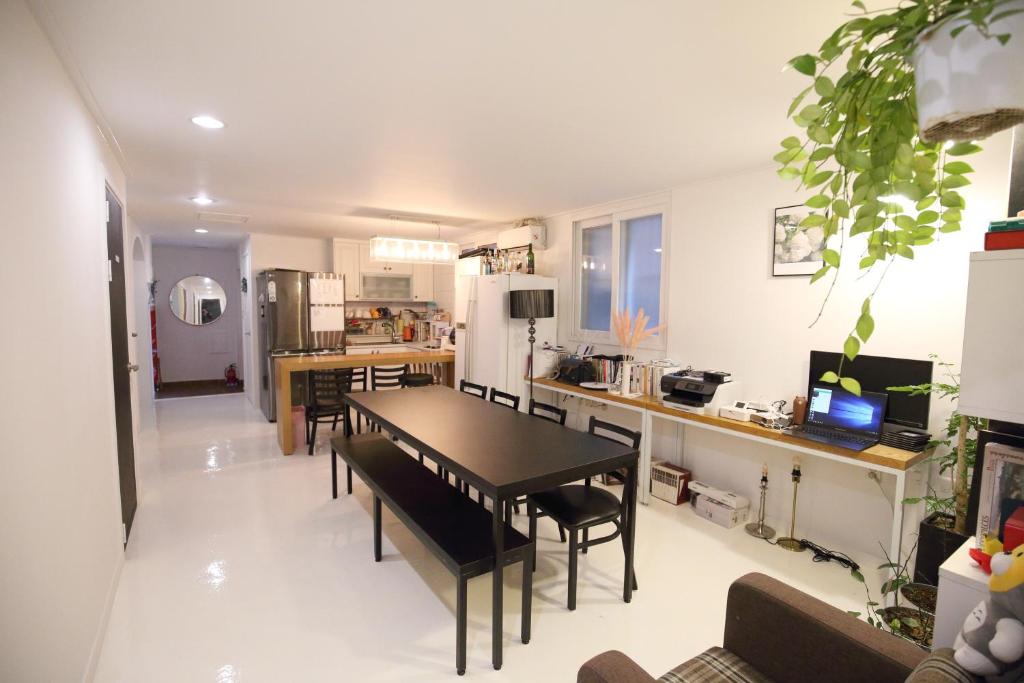 a kitchen and dining room with a table and chairs at Zibro S in Seoul