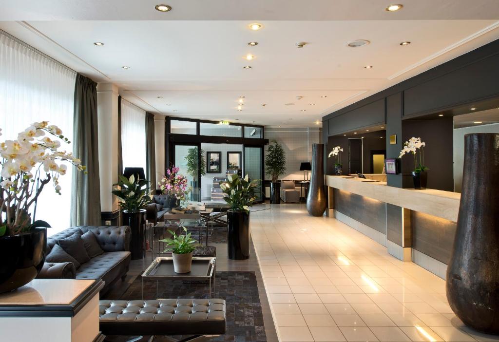 ハンブルクにあるPark Hotel Hamburg Arenaのソファとテーブルのあるホテルのロビー