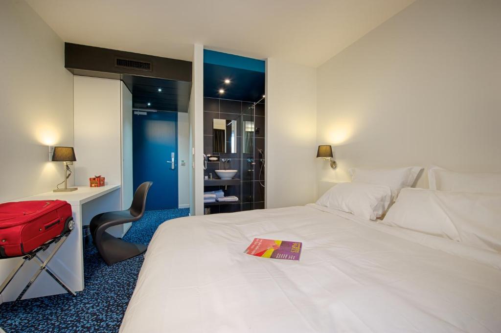 Letto o letti in una camera di Nex Hôtel