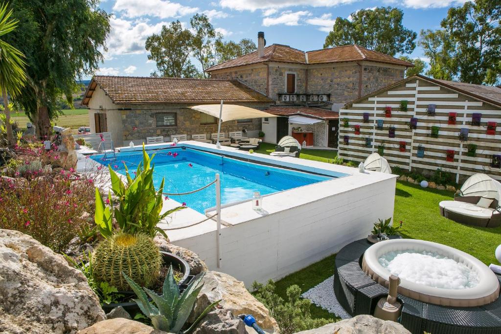 a swimming pool in the yard of a house at Villa Naumanni in Tarquinia