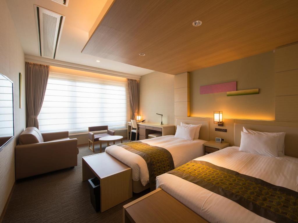 Cama ou camas em um quarto em Kanazawa Sainoniwa Hotel