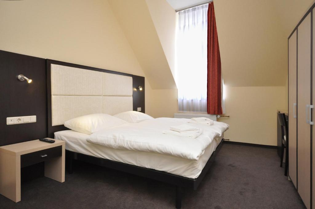 Postel nebo postele na pokoji v ubytování Hotel Bova