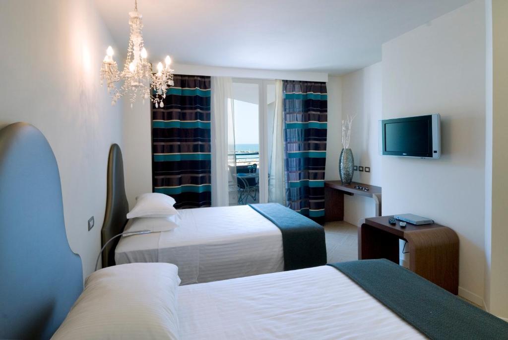 Postel nebo postele na pokoji v ubytování Blu Suite Resort