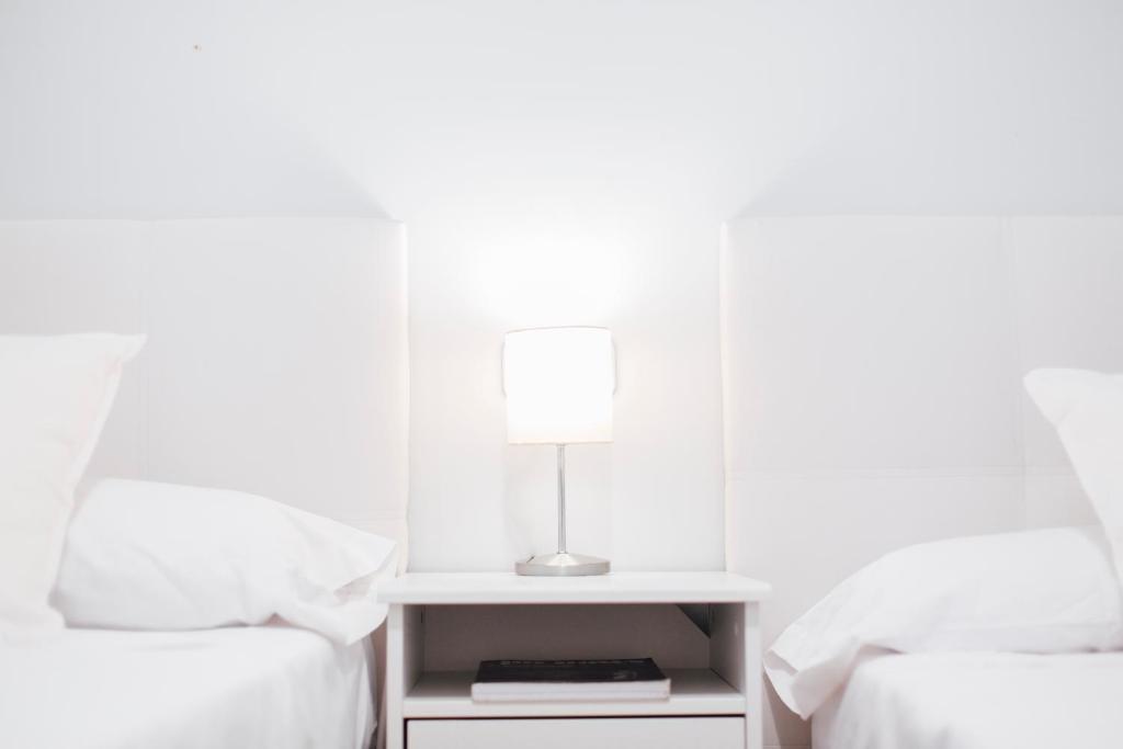 Postel nebo postele na pokoji v ubytování One & Lux- Lagar