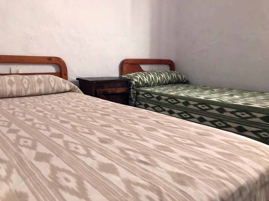 Un pat sau paturi într-o cameră la Casa Maria Luisa
