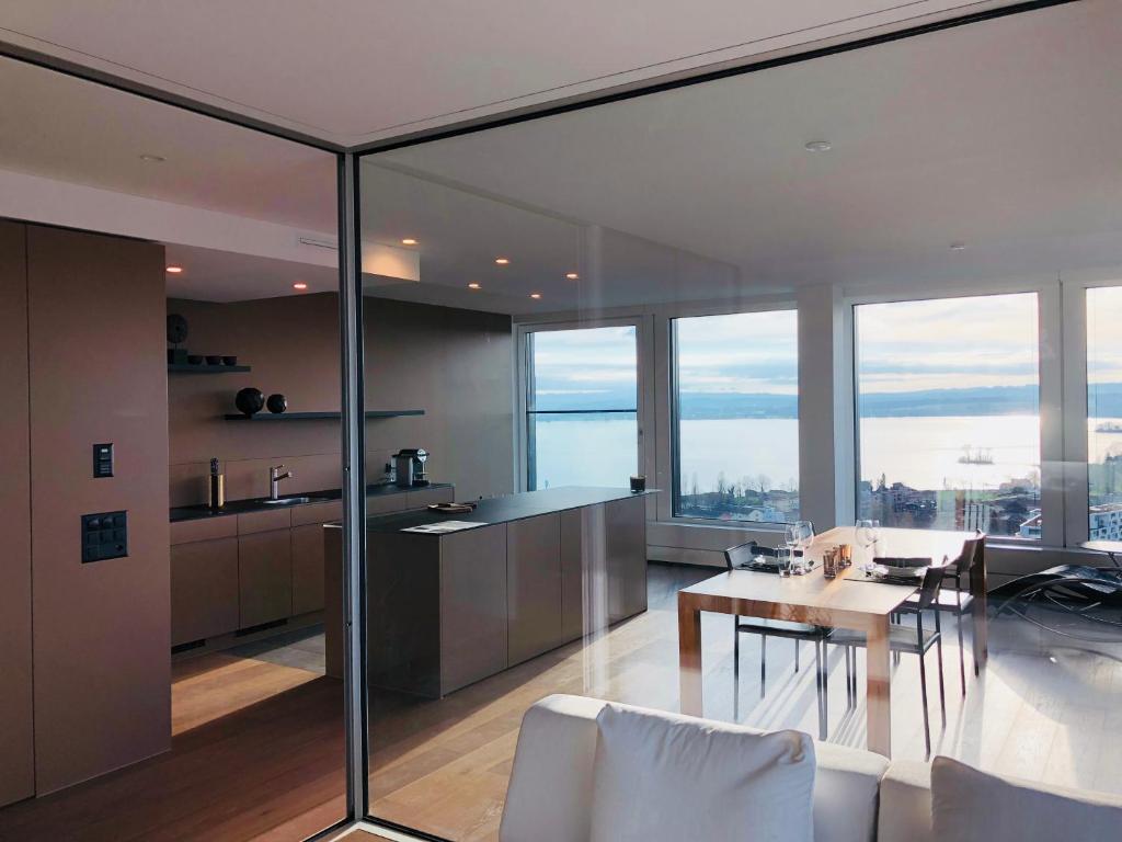 a kitchen and dining room with a table and chairs at Park Tower City View Apartments in Zug