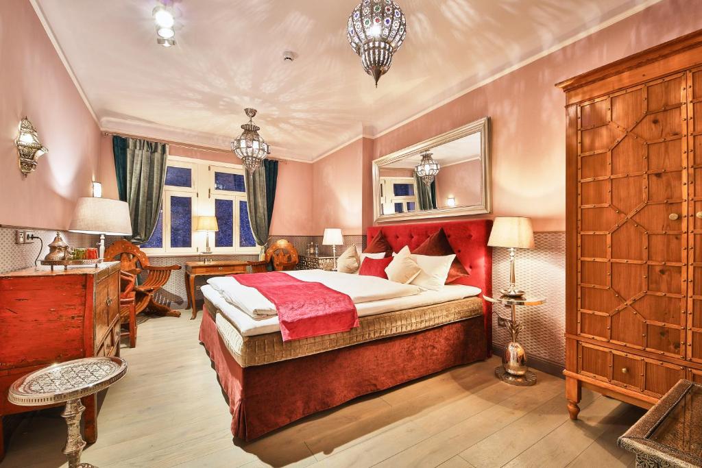 a bedroom with a large bed in a room at Bio-Hotel Villa Waldfrieden in Bad Schandau