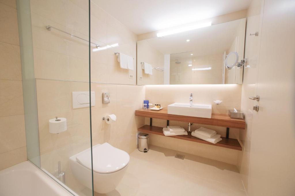a bathroom with a toilet and a sink and a shower at Grand Hotel Bernardin in Portorož