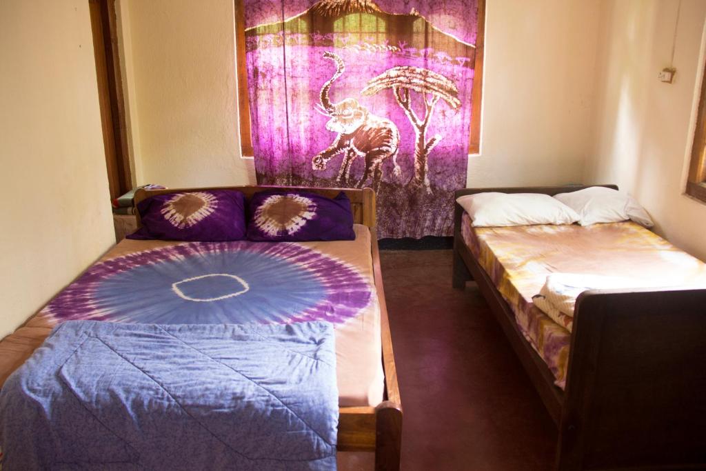 pokój z 2 łóżkami i kanapą w obiekcie Machame Nkweshoo Cultural Tourism w mieście Machame