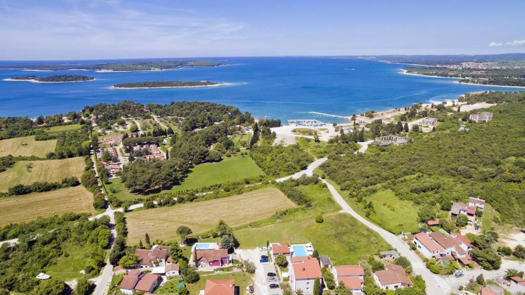 an aerial view of a house and the water at Astinian apartments Jadranka in Pula
