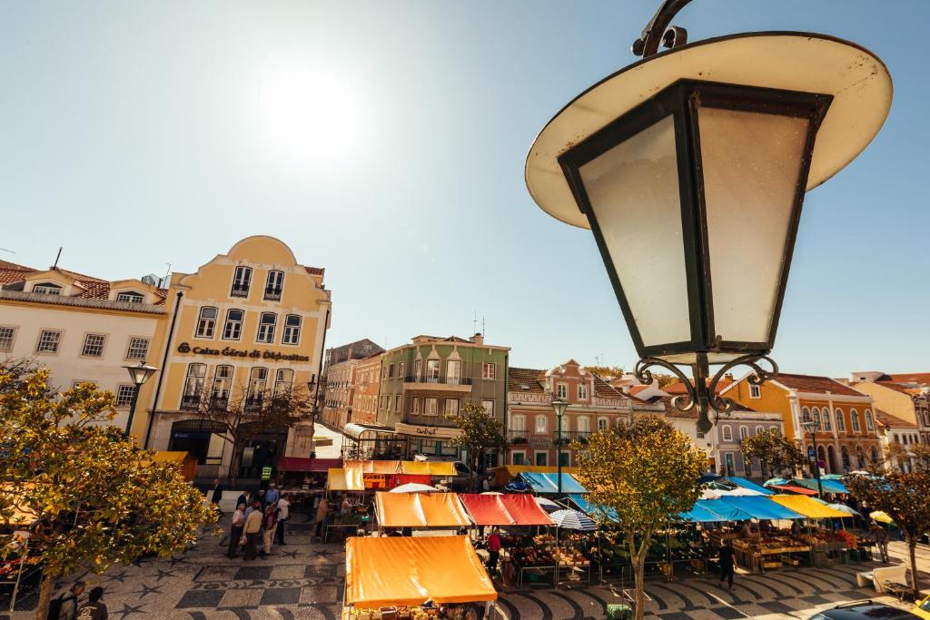 a city street with a street light and a market at Bordallo's Prime Apartments in Caldas da Rainha