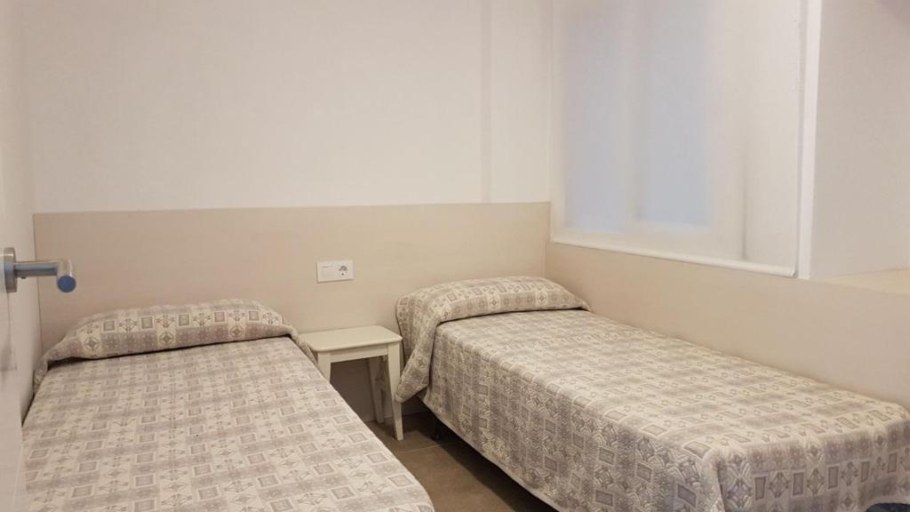 Postel nebo postele na pokoji v ubytování Apartaments Tropic