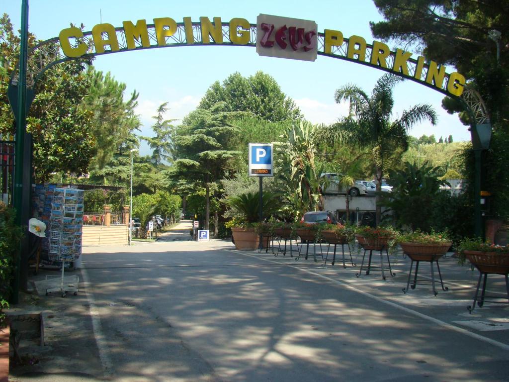 an empty street with a sign that reads camping yards at Camping Zeus in Pompei