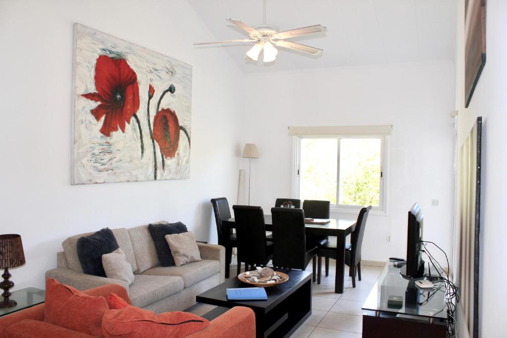 a living room with a couch and a table at Limnaria Westpark in Paphos City