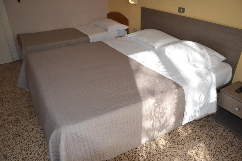 Postel nebo postele na pokoji v ubytování Hotel Britta